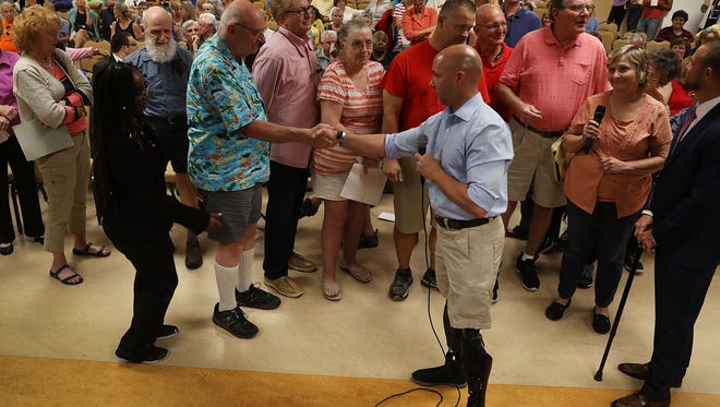 Rep. Brian Mast, R-Fla., shakes hands with Bob Fishel during a town hall meeting at the Havert L. Fenn Center on Feb. 24, 2017, in Fort Pierce, Fla.