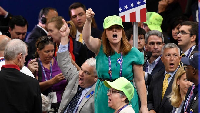 Members of the Virginia rebel against rules requiring them to vote for Donald Trump on the first ballot at the Republican National Convention, July 18.