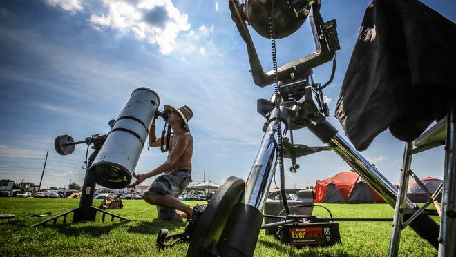 Brian Badgett of Louisville checks out one of his two telescopes in a soccer field transformed into a campground on Sunday afternoon.
August 20, 2017