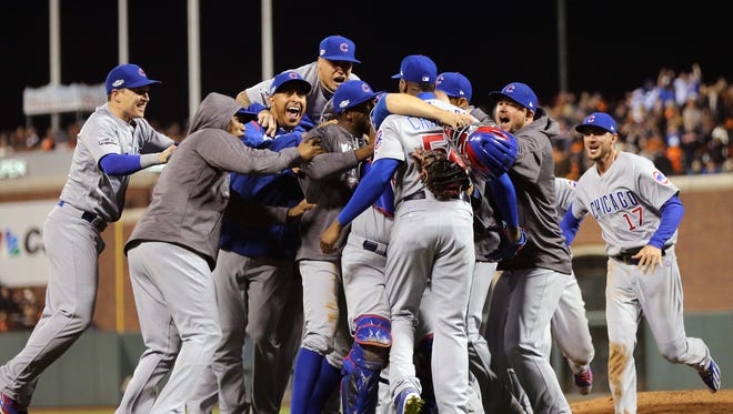 ... and the Cubs celebrate after Aroldis Chapman closes out the ninth inning.
