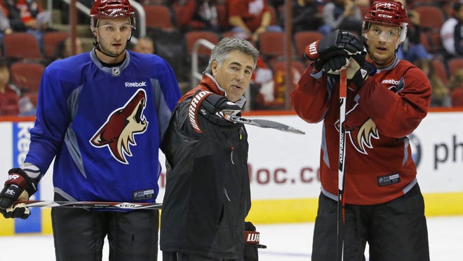Arizona Coyotes head coach Dave Tippett gives directions during training camp.