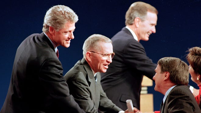 Clinton, Perot and Bush shake hands with the panelists following their third and final presidential debate at Michigan State University in East Lansing, Mich., on Oct. 19, 1992. At right is moderator Jim Lehrer of PBS.
