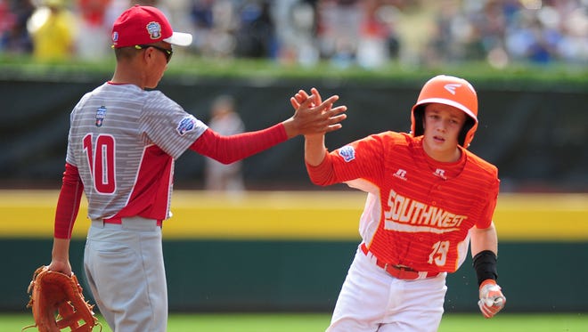 Texas hitter Chandler Spencer (19) even got a high-five from Japan shortstop Keitaro Miyahara (10) after leading off the game with a home run.