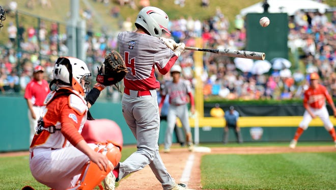Japan hitter Ryusei Fujiwara (4) connects on an RBI single during the second inning against Texas.