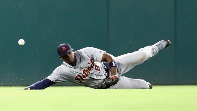 Tigers leftfielder Justin Upton dives for an RBI single by Rangers rightfielder Nomar Mazara in the fourth inning on Tuesday, Aug. 15, 2017, in Arlington, Texas.