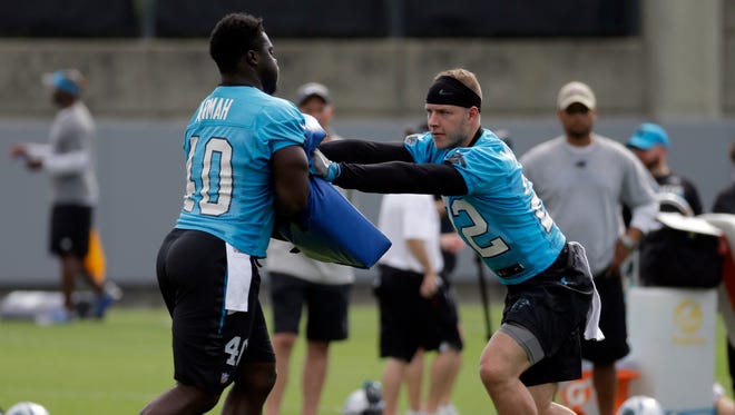 Carolina Panthers' Christian McCaffrey, right, runs a drill against Alex Armah, left, during the NFL football team's minicamp in Charlotte, N.C., Thursday, June 15, 2017.