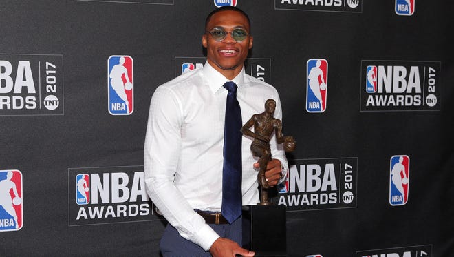 Russell Westbrook poses for photos with his 2017 NBA most valuable player award.