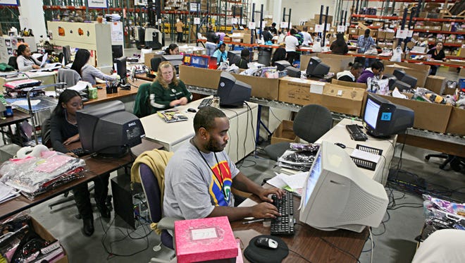 Employees at New Berlin's BuySeasons Inc. work on processing and crediting returns in this 2011 photo.