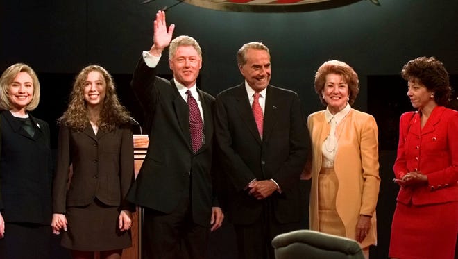 From left, Hillary Clinton, Chelsea Clinton, Bill Clinton, Bob Dole, Elizabeth Dole and Robin Dole pose for photographers after the presidential debate at the Bushnell theater in Hartford, Conn., on Oct. 6, 1996.
