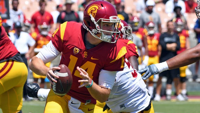 USC quarterback Sam Darnold scrambles from a tackler during the annual spring game at the Los Angeles Memorial Coliseum.
