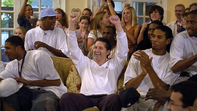 March 12, 2006 - Surrounded by his team, University of Memphis Basketball Coach John Calipari celebrates the announcement on television of the Tiger's number 4 seed at the NCAA tournament Sunday evening at Calipari's home.