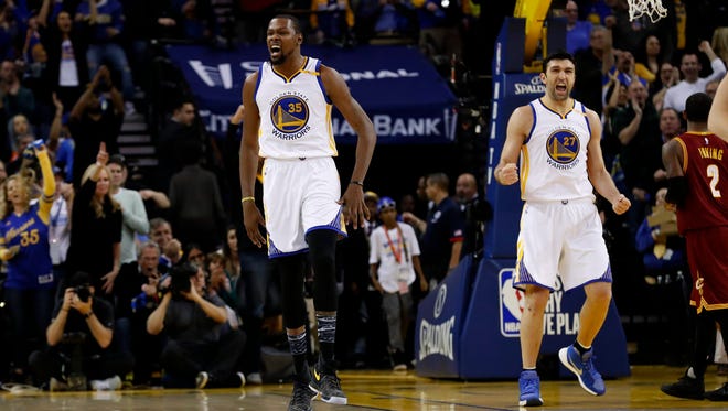 Kevin Durant and Zaza Pachulia celebrate after a Durant basket.