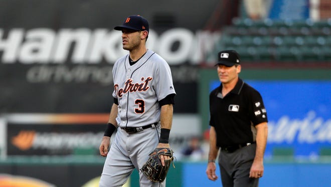 Tigers second baseman Ian Kinsler (3) stands by second as umpire Angel Hernandez, right, watches play during the second inning on Wednesday, Aug. 16, 2017, in Arlington, Texas.