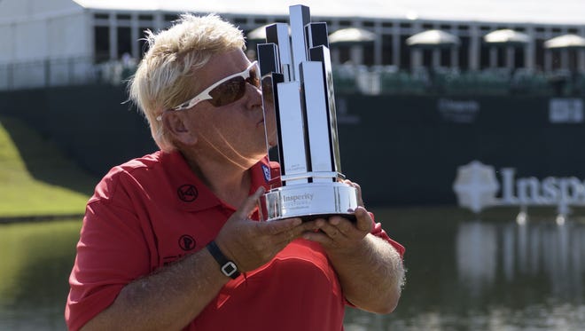 John Daly kisses the trophy after winning the Insperity Invitational golf tournament on Sunday, May 7, 2017, in The Woodlands, Texas.