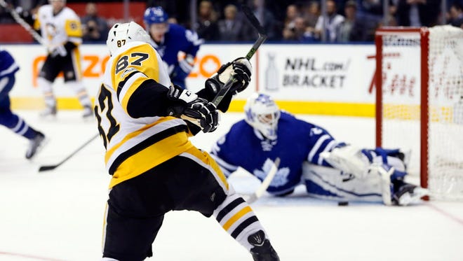 April 8: Toronto Maple Leafs goaltender Curtis McElhinney (35) makes a save on Pittsburgh Penguins forward Sidney Crosby (87) at the Air Canada Centre.