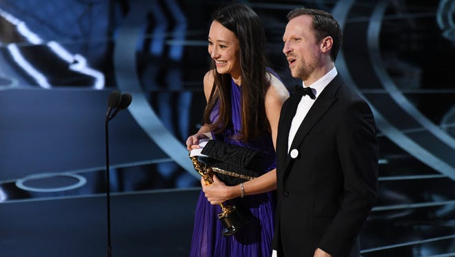 Joanna Natasegara and Orlando von Einsiedel accept the award for Best documentary short subject for 'The White Helmets' during the 89th Academy Awards.