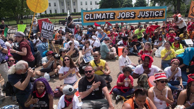 Protesters chant in front of the White House during the People's Climate March in Washington, DC, on April 29, 2017.