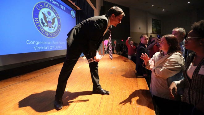 Rep. Scott Taylor, R-Va., stops to talk to constituents as he leaves the stage after concluding a town hall meeting in Yorktown, Va., on Feb. 21, 2017.