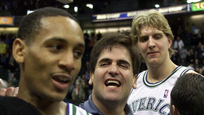 2001: Dallas Mavericks owner Mark Cuban celebrates with Howard Eisley and Dirk Nowitzki.