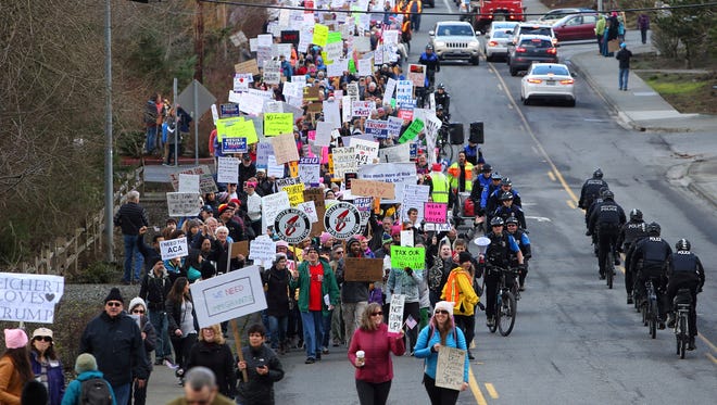 Protesters march up the hill to Washington Republican Rep. Dave Reichert's office in Issaquah on Feb. 23, 2017. Some of Reichert's constituents say he is avoiding them by skipping town hall meetings and refusing phone calls.