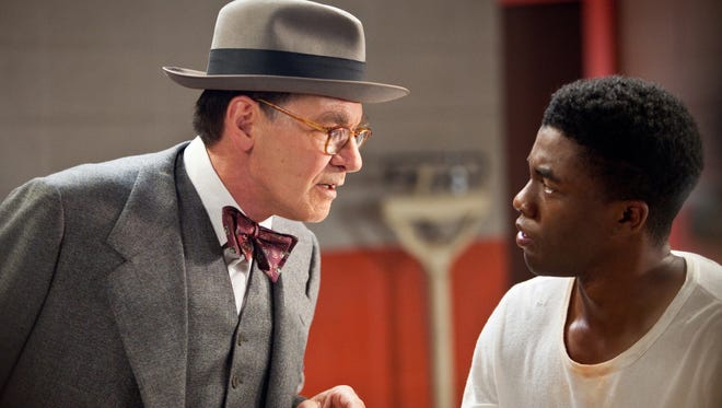 Harrison Ford, left, plays Branch Rickey and Chadwick Boseman plays baseball legend Jackie Robinson in  "42."