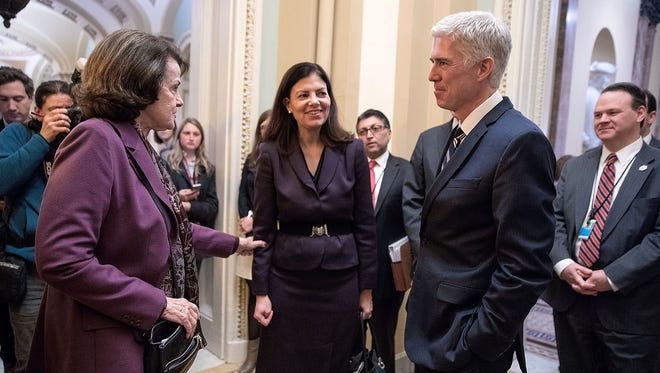 Former Republican senator Kelly Ayotte, center, introduces Gorsuch to Sen. Dianne Feinstein, D-Calif., in the hallway of the U.S. Capitol on Feb. 1, 2017.