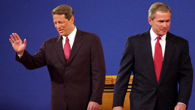 Al Gore and George W. Bush move to their spots to begin their Oct. 3, 2000, debate at the University of Massachusetts-Boston.