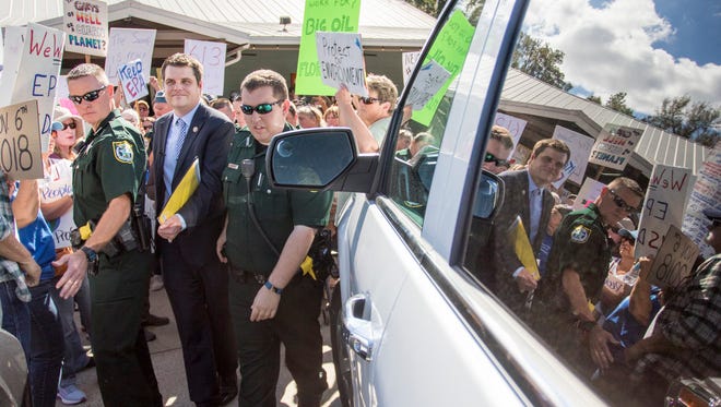 Rep. Matt Gaetz, R-Fla., is escorted by Santa Rosa County Sheriff's Office deputies as he makes his way to his car following a meeting with constituents in Milton, Fla., on Feb. 23, 2017.