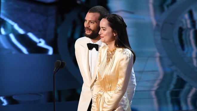 Jamie Dornan and Dakota Johnson present the award for Achievement in production design during the 89th Academy Awards.
