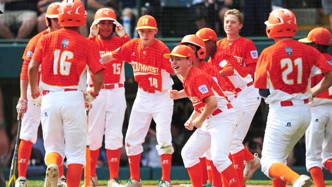 Texas celebrates as Hunter Ditsworth (16) crosses home plate after his first-inning home run.