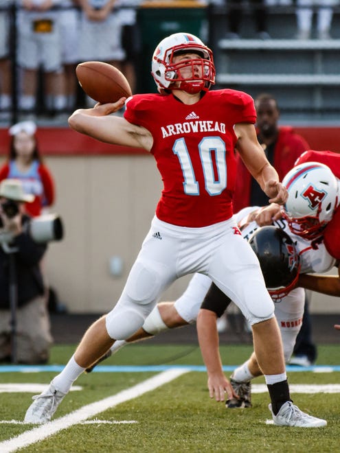 Arrowhead quarterback Henry Case (10) launches a pass downfield during the game at home against Muskego on Thursday, Aug. 24, 2017.