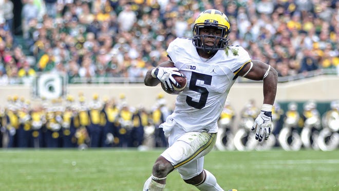 Michigan Wolverines linebacker Jabrill Peppers (5) runs the ball during the first half of a game against the Michigan State Spartans at Spartan Stadium.