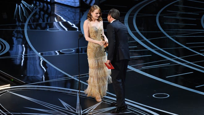 Emma Stone accepts the Oscar for Best Actress from Leonardo DiCaprio for her role in 'La La Land' during the 89th Academy Awards.