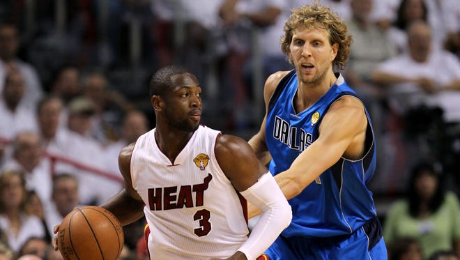 2011: Dwyane Wade looks to pass against Dirk Nowitzki in Game 2 of the 2011 NBA Finals.