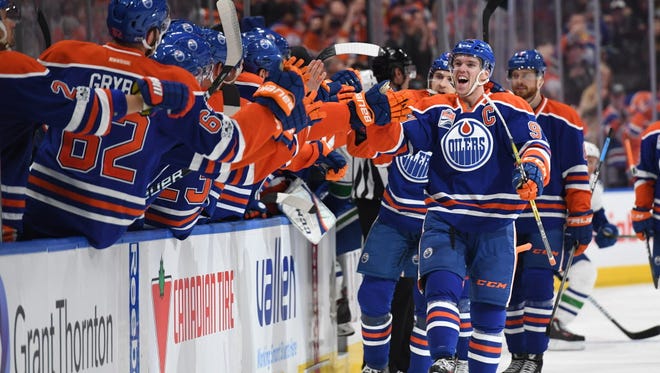 April 9: Edmonton Oilers center Connor McDavid (97) celebrates his 100th point of the season off a goal by Leon Draisaitl (not pictured) in the third period against the Vancouver Canucks.