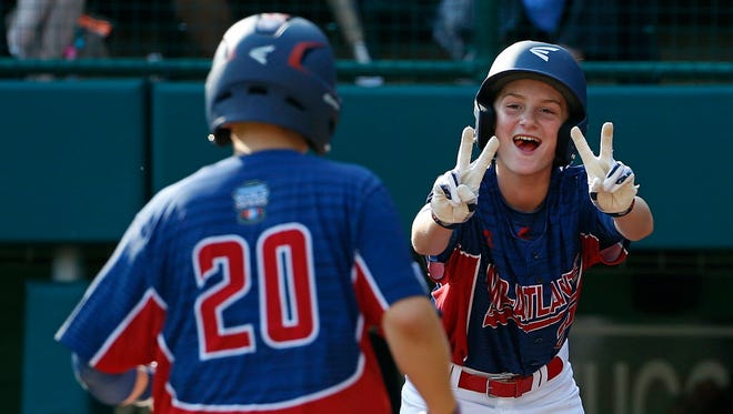 Jackson, N.J.,'s R.J. Vashey (20) is greeted at home plate by Anthony Abbonizio after hitting a two-run home run off Rancho Santa Margarita, Calif., pitcher Joey Gray (15) in the third inning of a baseball game in United States pool play at the Little League World Series tournament in South Williamsport, Pa.