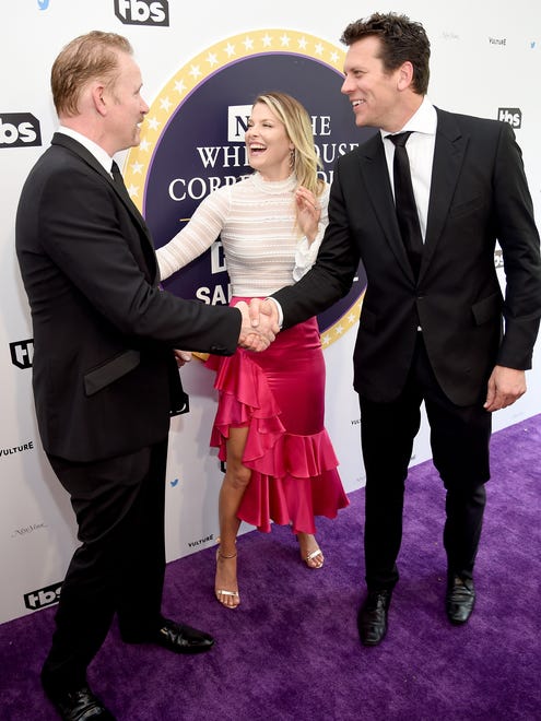 Documentary filmmaker Morgan Spurlock, left, actress Ali Larter and 'Angie Tribeca' star Hayes MacArthur greet each other on the purple carpet.