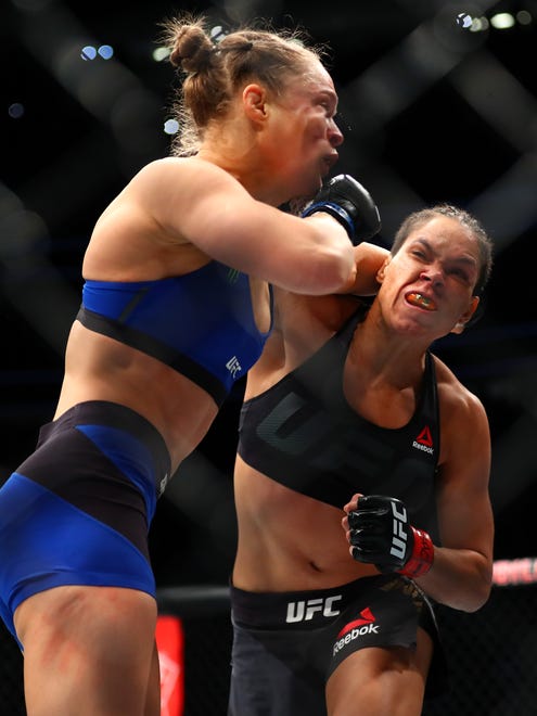 Amanda Nunes lands a punch to the face of Ronda Rousey.