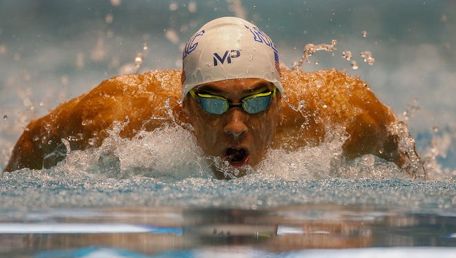 Michael Phelps swims the 200-meter individual medley during the AT&T Winter National Championships at the Weyerhaeuser King County Aquatic Center.