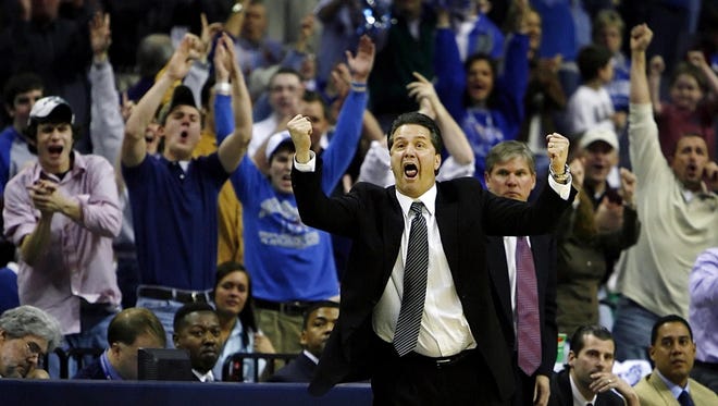 January 27, 2007 - Memphis' head coach John Calipari, middle, cheers on his team after they tied the score agasint Southern Miss during seond half action. Memphis defeated Southern Miss 67-64.