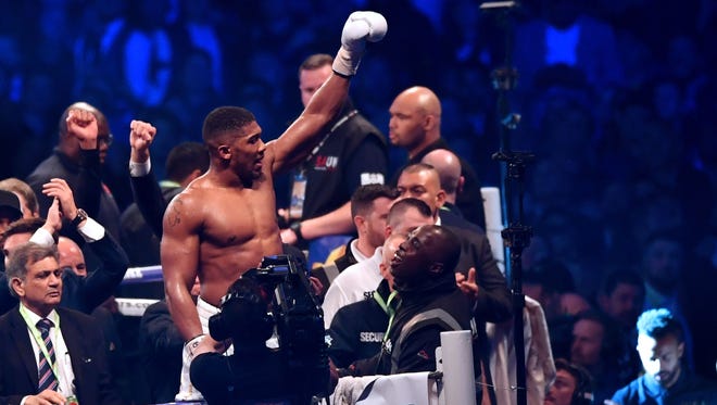 Britain's Anthony Joshua celebrates in the ring after his victory over Ukraine's Wladimir Klitschko in the eleventh round of their IBF, IBO and WBA, world Heavyweight title fight at Wembley Stadium.