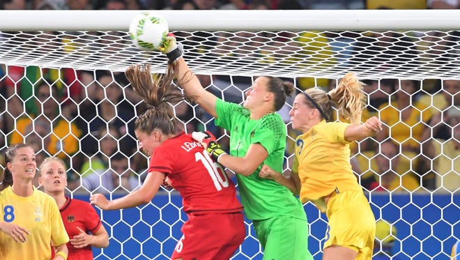 Germany goalkeeper Almuth Schult (1) makes a save against Sweden during the women's soccer gold medal game.