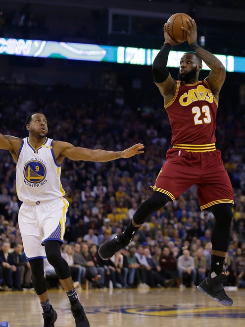 LeBron James shoots over Andre Iguodala during the first half.