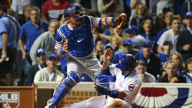 NLCS, Game 1: Javier Baez steals home ahead of the tag by Dodgers catcher Carlos Ruiz. He becomes the first Cubs player to steal home in a postseason game since 1907.