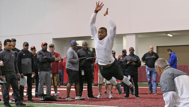 DeMarcus Walker performs the standing broad jump drill for NFL scouts during Florida State's pro day, Tuesday, March 28, 2017 in Tallahassee, Fla.