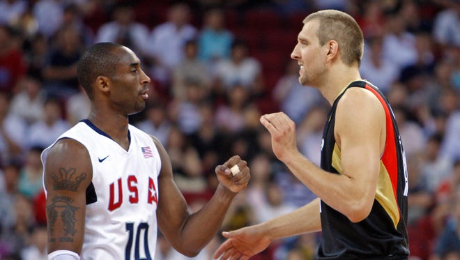 2008: Kobe Bryant shakes hands with Dirk Nowitzki before a preliminary round game at the Beijing Olympic Basketball Gymnasium during the 2008 Beijing Olympic Games.