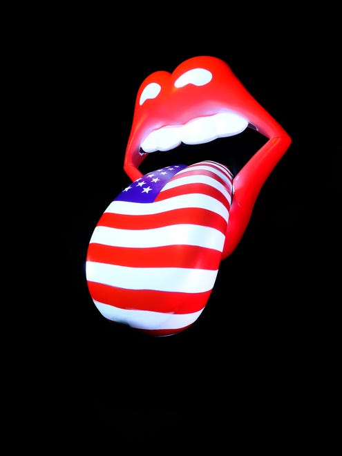 A light-up lips-and-tongue logo, designed by John Pasche, is prominently featured in the gallery.