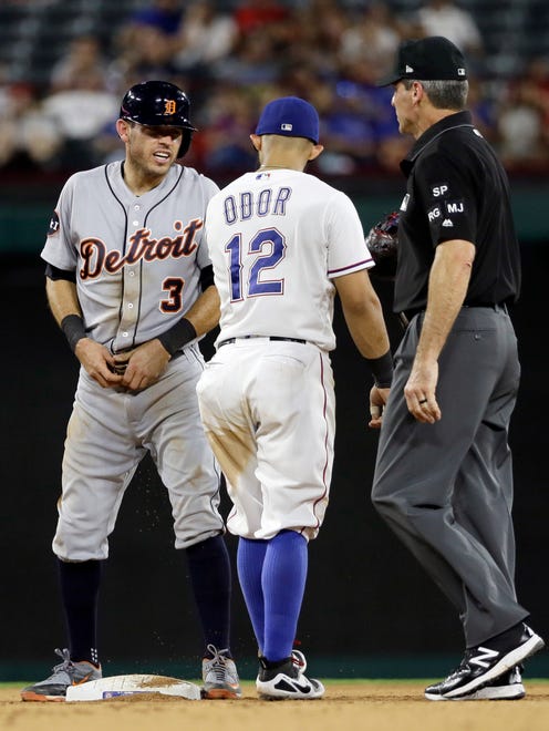 Tigers second baseman Ian Kinsler (3) talks with Rangers second baseman Rougned Odor (12) and base umpire Angel Hernandez, right, after stealing second during the fifth inning of the Tigers' 12-6 loss to the Rangers on Wednesday, Aug. 16, 2017, in Arlington, Texas.