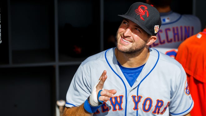 Tim Tebow arrives at Mets camp on Monday.