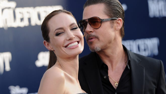 Angelina Jolie and Brad Pitt arrive May 28, 2014 at the premiere of Disney's 'Maleficent' at the El Capitan Theatre in Hollywood.